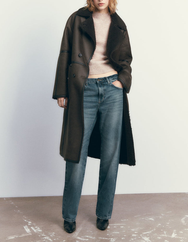 Woman in a long double-breasted belted coat