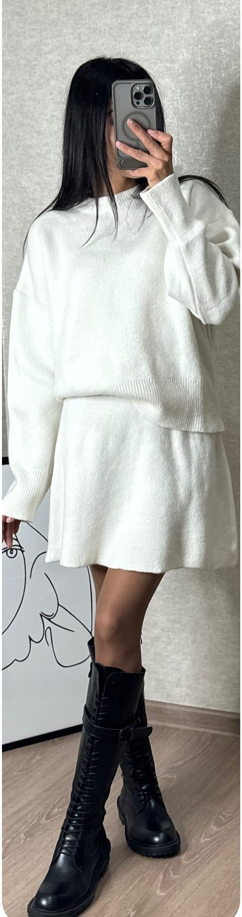 Woman in matching knitted jumper and mini skirt