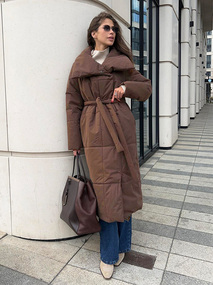 Woman in a long quilted coat with belt