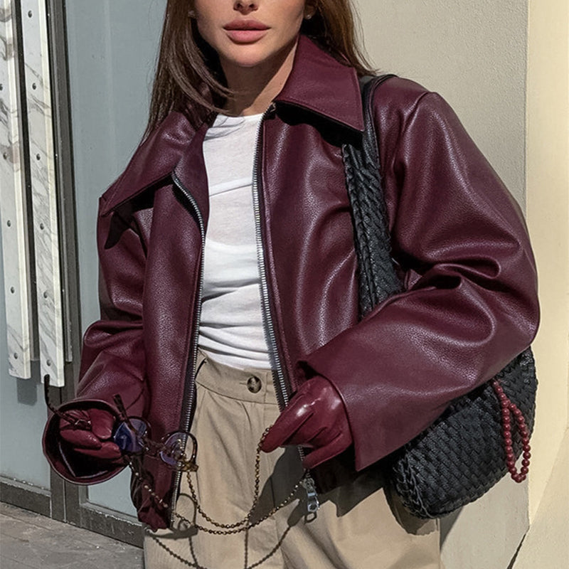 Woman in a cropped burgundy faux leather jacket